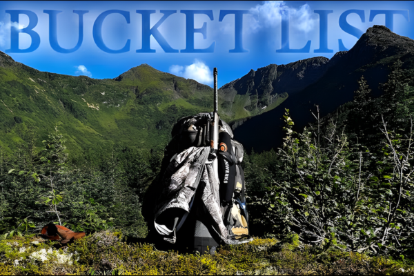 Backpack and rifle set against Alaskan mountain backdrop during hunting season